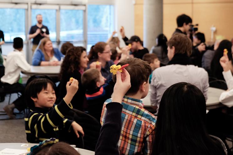 Children and adults playing LEGO