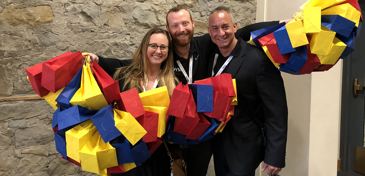 All smiles while LEGO Facilitator trainers hold up LEGO giftbags to share