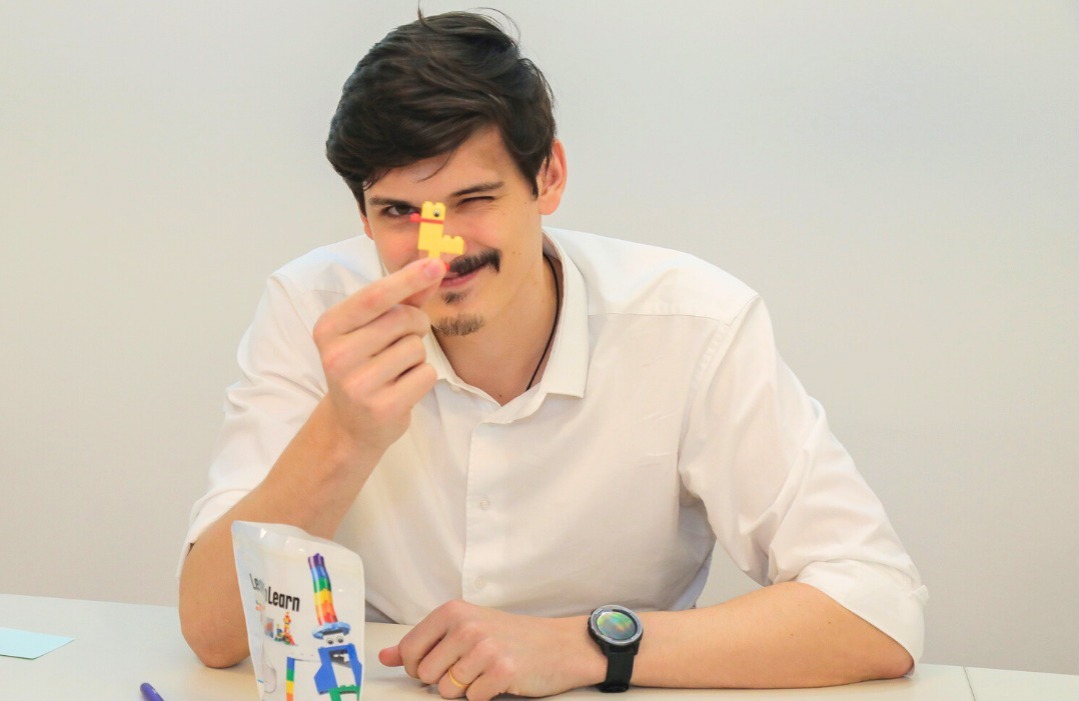 Man holds up LEGO duck during LEGO Serious Play training session